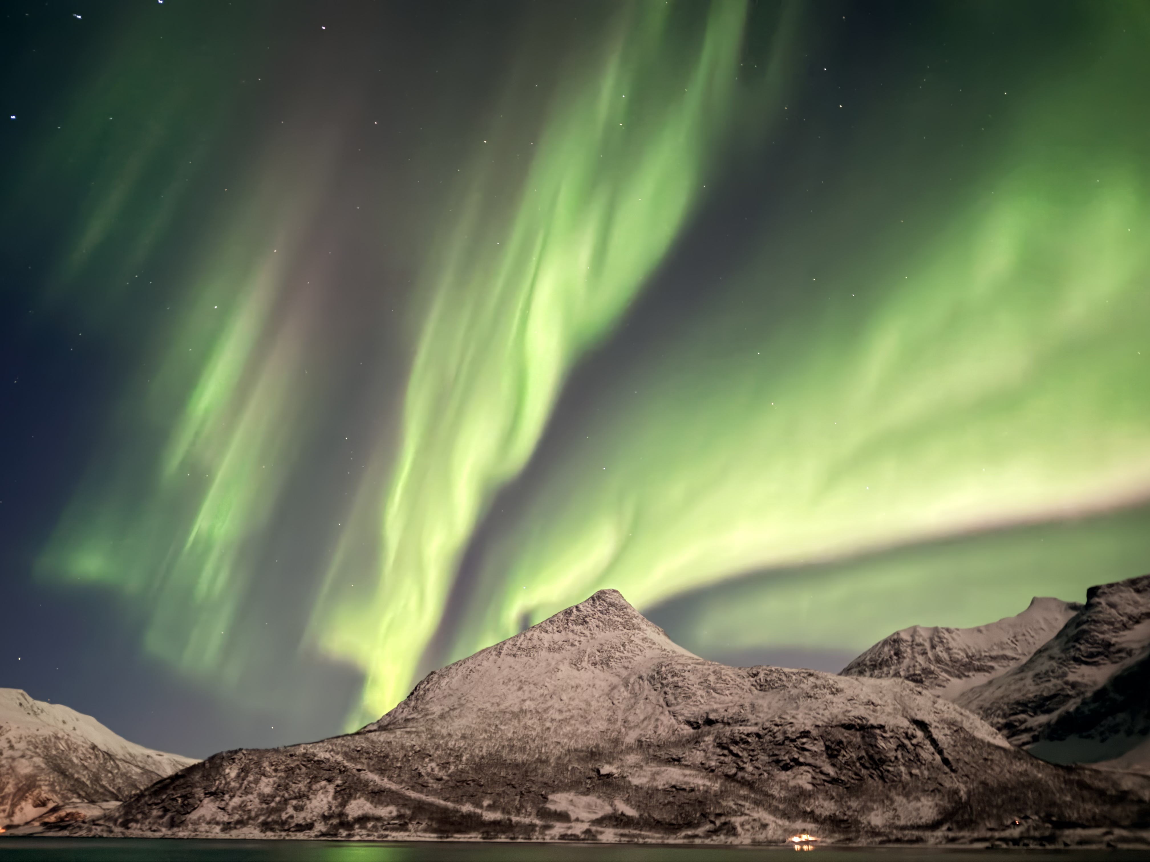 Aurora rising over a central snow peak