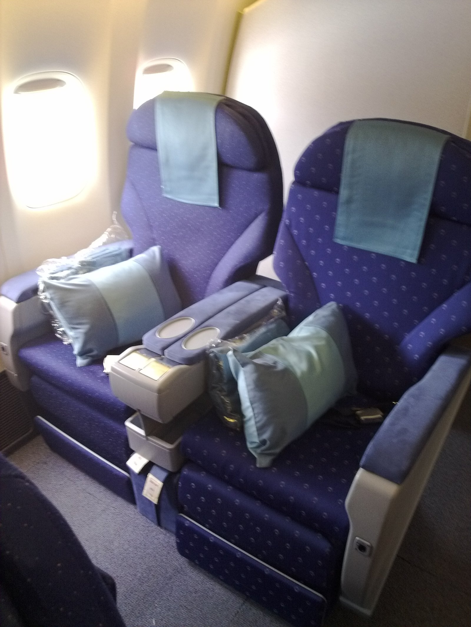 Empty business seats by an aircraft window